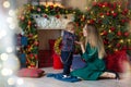 Portrait of happy mother and adorable baby celebrate Christmas. New Year`s holidays. Toddler with mom in the festively decorated Royalty Free Stock Photo