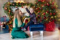 Portrait of happy mother and adorable baby celebrate Christmas. New Year`s holidays. Toddler with mom in the festively decorated Royalty Free Stock Photo