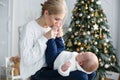 Portrait of happy mother and adorable baby celebrate Christmas. Royalty Free Stock Photo