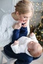 Portrait of happy mother and adorable baby celebrate Christmas. Royalty Free Stock Photo