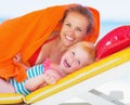 Portrait of happy mother and baby laying on chaise-longue Royalty Free Stock Photo