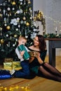 Portrait of a happy mother and a charming child celebrating Christmas. New year holiday. Baby with his mother in a festively Royalty Free Stock Photo