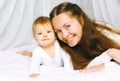 Portrait happy mother and cute baby on the bed home Royalty Free Stock Photo