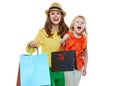 Portrait of happy mother and daughter showing shopping bags