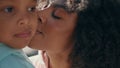 Portrait happy mother daughter at summer sunlight. African woman kissing child. Royalty Free Stock Photo