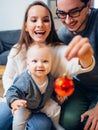 Mother, father and baby holding bauble Royalty Free Stock Photo