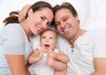 Portrait of a happy mother and father smiling with cute baby Royalty Free Stock Photo