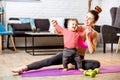 Mother exercising with her baby son at home Royalty Free Stock Photo