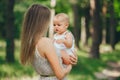 Portrait of happy mother and her baby in the summer forest