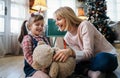 Portrait of happy mother and her child girl playing and having fun together at home Royalty Free Stock Photo