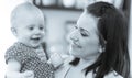 Portrait of happy mother with her cute baby girl, black and white Royalty Free Stock Photo