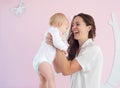 Portrait of happy mother holding cute baby at home Royalty Free Stock Photo