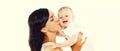 Portrait of happy mother holding and kissing her cute baby on white background, blank copy space for advertising text Royalty Free Stock Photo