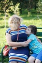 Portrait of a happy mother and son smiling outdoors Royalty Free Stock Photo