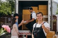 Portrait of a happy mover working unloading boxes into a new home from a truck Royalty Free Stock Photo