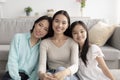 Portrait of happy multi generation Asian family sitting on floor and smiling at camera at home Royalty Free Stock Photo