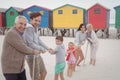 Portrait of happy multi-generation family playing tug of war Royalty Free Stock Photo