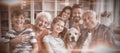 Portrait of happy multi generation family sitting on sofa in living room Royalty Free Stock Photo