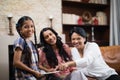 Portrait of happy multi-generation family using digital tablet at home Royalty Free Stock Photo