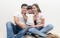 Portrait Of Happy multiethnic family sitting on floor with children and looking at camera. Family and childhood concept Royalty Free Stock Photo