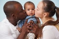 Portrait of happy multiracial family against pale blue background