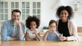 Happy multiracial family drinking pure mineral water in kitchen Royalty Free Stock Photo