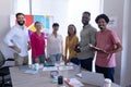 Portrait of happy multiracial professionals standing together in boardroom during meeting at office Royalty Free Stock Photo