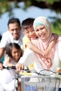 Portrait of happy muslim family riding bikes together