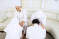 Muslim family forgiving each other in living room Royalty Free Stock Photo