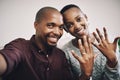 Look who just got engaged. Portrait of a happy newly engaged young couple taking selfies and showing their engagement Royalty Free Stock Photo