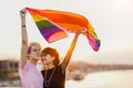 Young gender fluid couple in love waving a rainbow flag Royalty Free Stock Photo