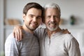 Portrait of happy old father and adult son hugging Royalty Free Stock Photo