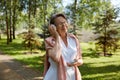 Portrait of satisfied old woman using mobile enjoying summer in park Royalty Free Stock Photo