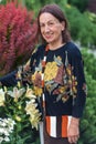 Portrait of happy older wrinkled smiling woman of eighty or ninety years old, staying in her garden.