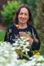 Portrait of happy older wrinkled smiling woman of eighty years old in her garden.