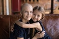 Portrait of happy optimistic cancer patient mom embracing daughter Royalty Free Stock Photo