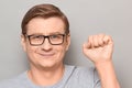 Portrait of happy optimistic man raising fist up and smiling Royalty Free Stock Photo