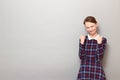 Portrait of happy overjoyed girl raising fists up in triumph