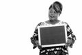 Portrait of happy overweight African woman thinking while holding blackboard Royalty Free Stock Photo