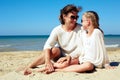 Portrait of a happy parent and child resting on the beach