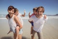 Portrait of happy parents piggybacking their children Royalty Free Stock Photo