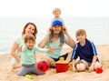 Portrait of happy parents and their children on sand Royalty Free Stock Photo