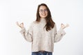 Portrait of happy peaceful good-looking woman in glasses and warm sweater keep calm as meditating smiling broadly at