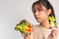 Portrait of a happy playful Asian girl eating fresh salad from a glass bowl after workout at home. Young lady Enjoying Healthy Royalty Free Stock Photo