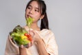 Portrait of a happy playful Asian girl eating fresh salad from a glass bowl after workout at home. Young lady Enjoying Healthy Royalty Free Stock Photo