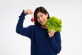 Portrait of a happy playful Asian girl eating fresh salad from a glass bowl after workout at home. Young lady Enjoying Healthy Royalty Free Stock Photo