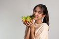 Portrait of a happy playful Asian girl eating fresh salad from a glass bowl after workout at home. Young lady Enjoying Healthy Royalty Free Stock Photo
