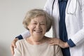 Happy positive elderly patient woman posing near geriatrician doctor Royalty Free Stock Photo