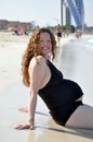 Portrait of a happy pregnant woman on the beach