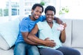 Portrait of happy pregnant woman holding baby shoes Royalty Free Stock Photo